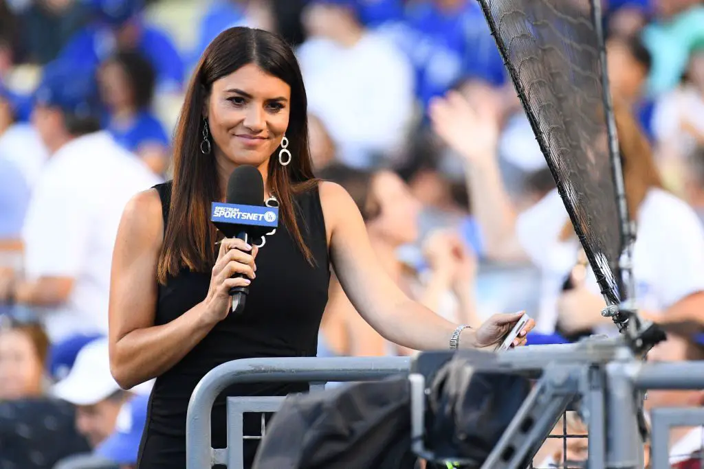 Alanna Rizzo holding Joc Pederson's baby while interviewing