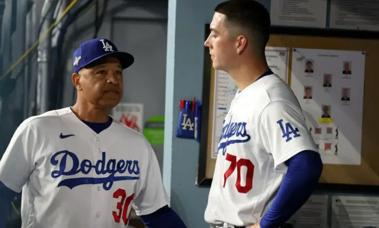 Oct 9, 2023; Los Angeles, California, USA; Los Angeles Dodgers manager Dave Roberts (30) talks with starting pitcher Bobby Miller (70) in the second inning for game two of the NLDS for the 2023 MLB playoffs at Dodger Stadium.