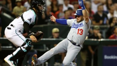 Oct 11, 2023; Phoenix, Arizona, USA; Los Angeles Dodgers third baseman Max Muncy (13) slides safely into home plate before Arizona Diamondbacks catcher Jose Herrera (11) can apply the tag in the seventh inning for game three of the NLDS for the 2023 MLB playoffs at Chase Field.