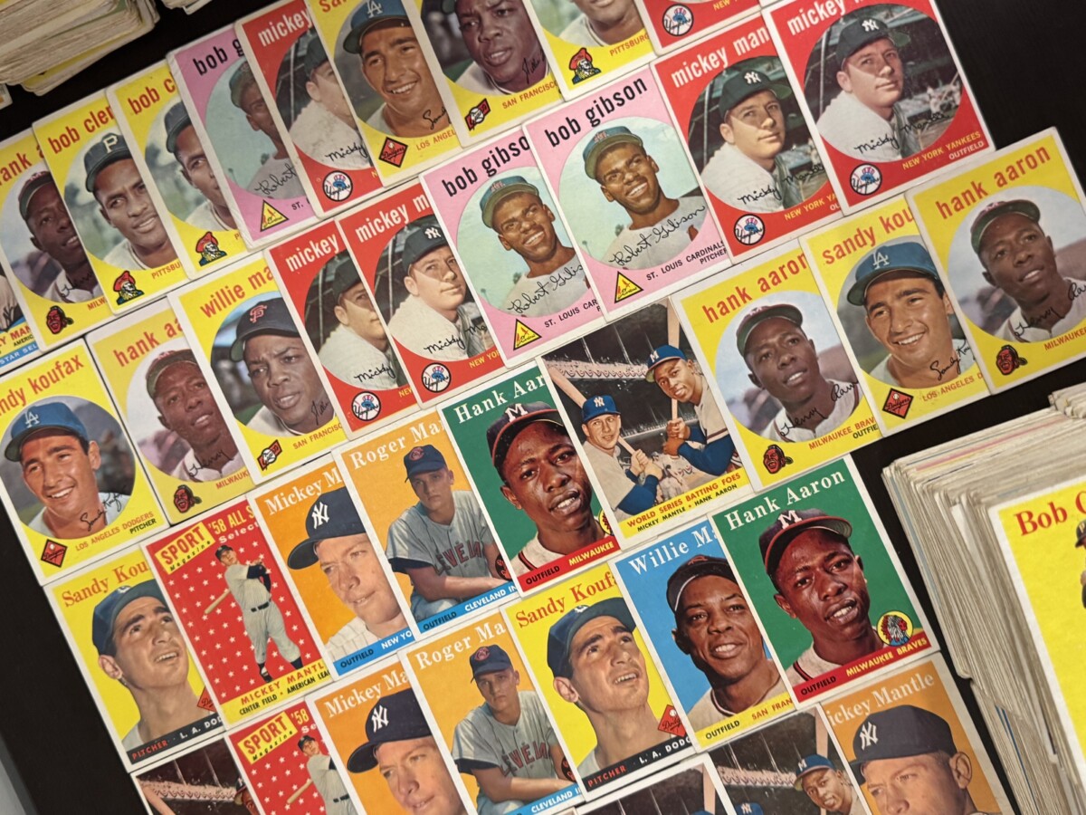 A collection of rare baseball cards are seen spread out in this image