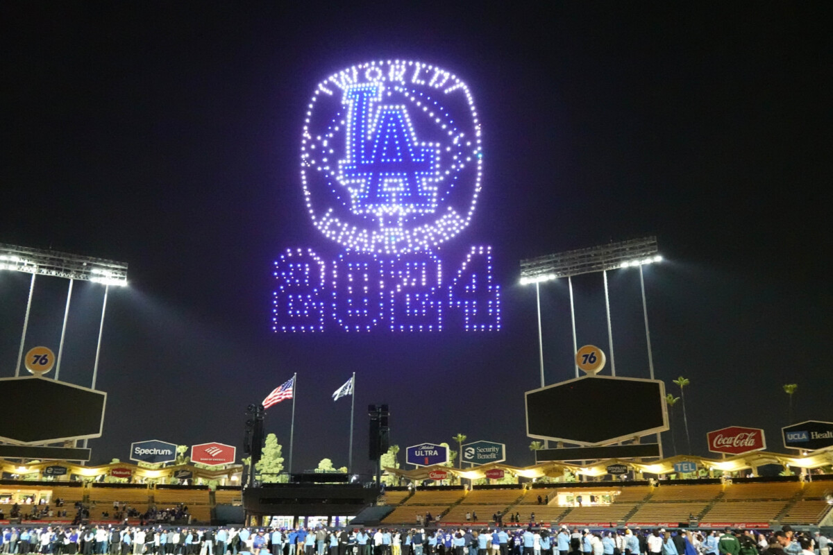 Mar 28, 2025; Los Angeles, California, USA; A Los Angeles Dodgers 2024 World Series Champion ring is projected during a drone show at Dodger Stadium. Mandatory Credit: Kirby Lee-Imagn Images