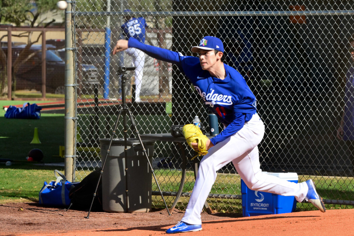 Los Angeles Dodgers pitcher Roki Sasaki (11) throws during a Spring Training workout at Camelback Ranch.