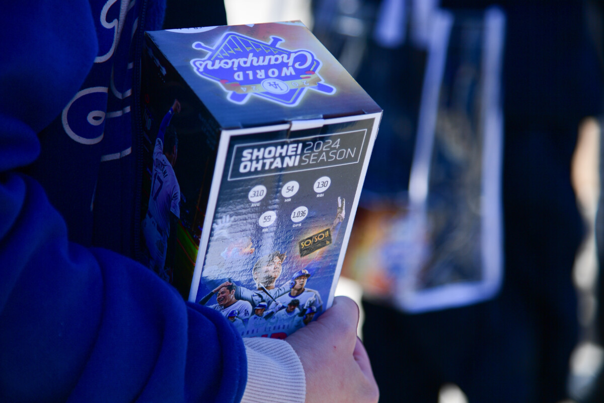 Spectators receive Shohei Ohtani bobblehead before the Los Angeles Dodgers play against the Atlanta Braves at Dodger Stadium.