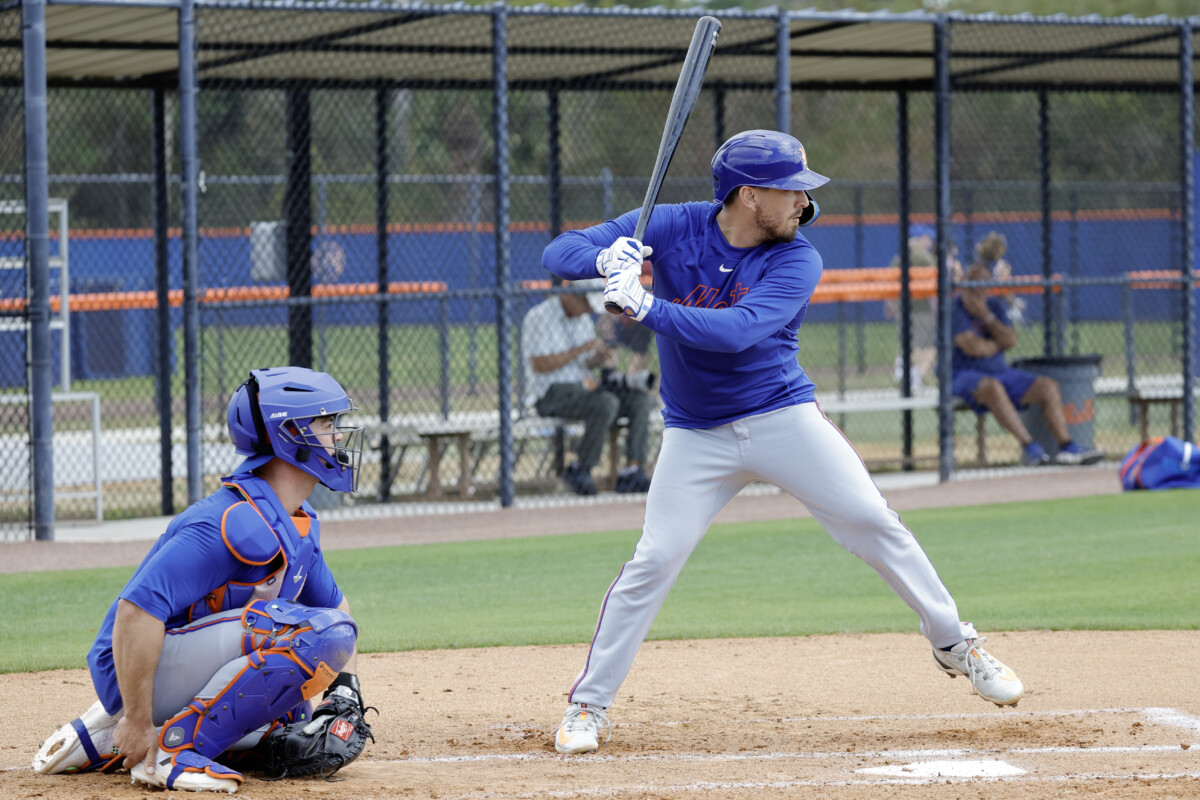 New York Mets catcher Austin Barnes (55) takes batting practice as catcher Ben Rortvedt (left) waits on the pitch during spring training workouts at Clover Park.