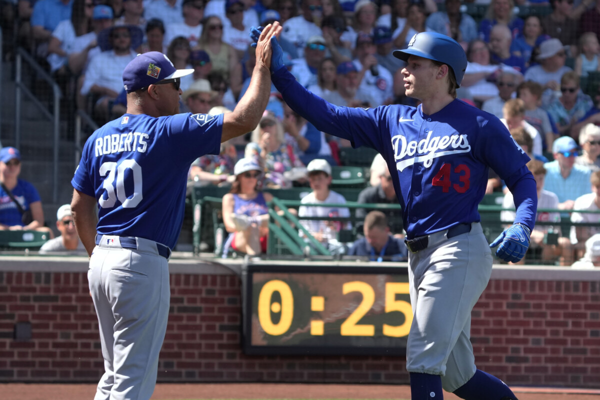 Los Angeles Dodgers right fielder Jack Suwinski celebrates with manager Dave Roberts (30) after hitting a three run home run against the Chicago Cubs in the first inning at Sloan Park.