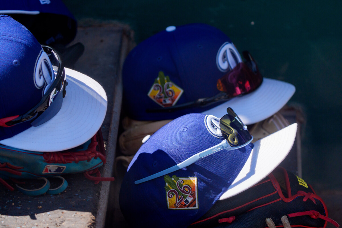 A detailed view as hats belonging to the Los Angeles Dodgers rest on the steps inside the dugout during a spring training game against the Chicago Cubs at Camelback Ranch-Glendale.