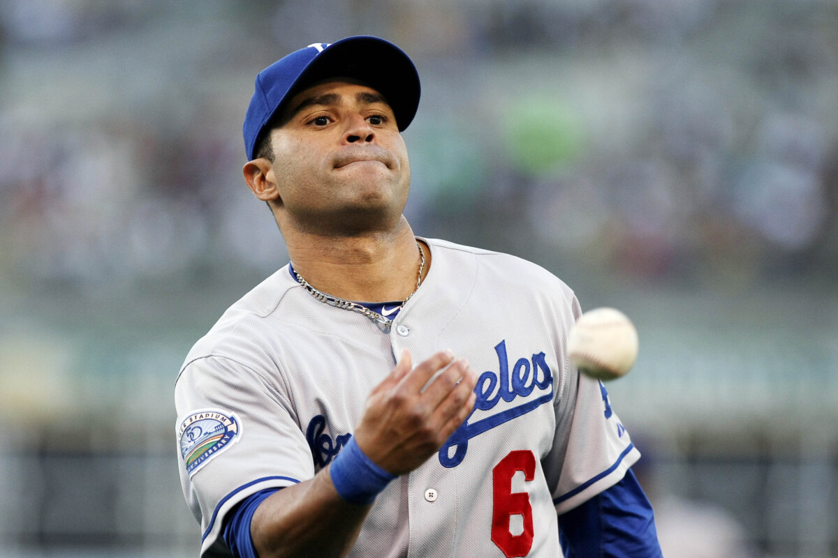 June 20, 2012; Oakland, CA, USA; Los Angeles Dodgers second baseman Jerry Hairston Jr. (6) throws the ball into the crowd against the Oakland Athletics during the second inning at O.co Coliseum. Mandatory Credit: Kelley L Cox-USA TODAY Sports