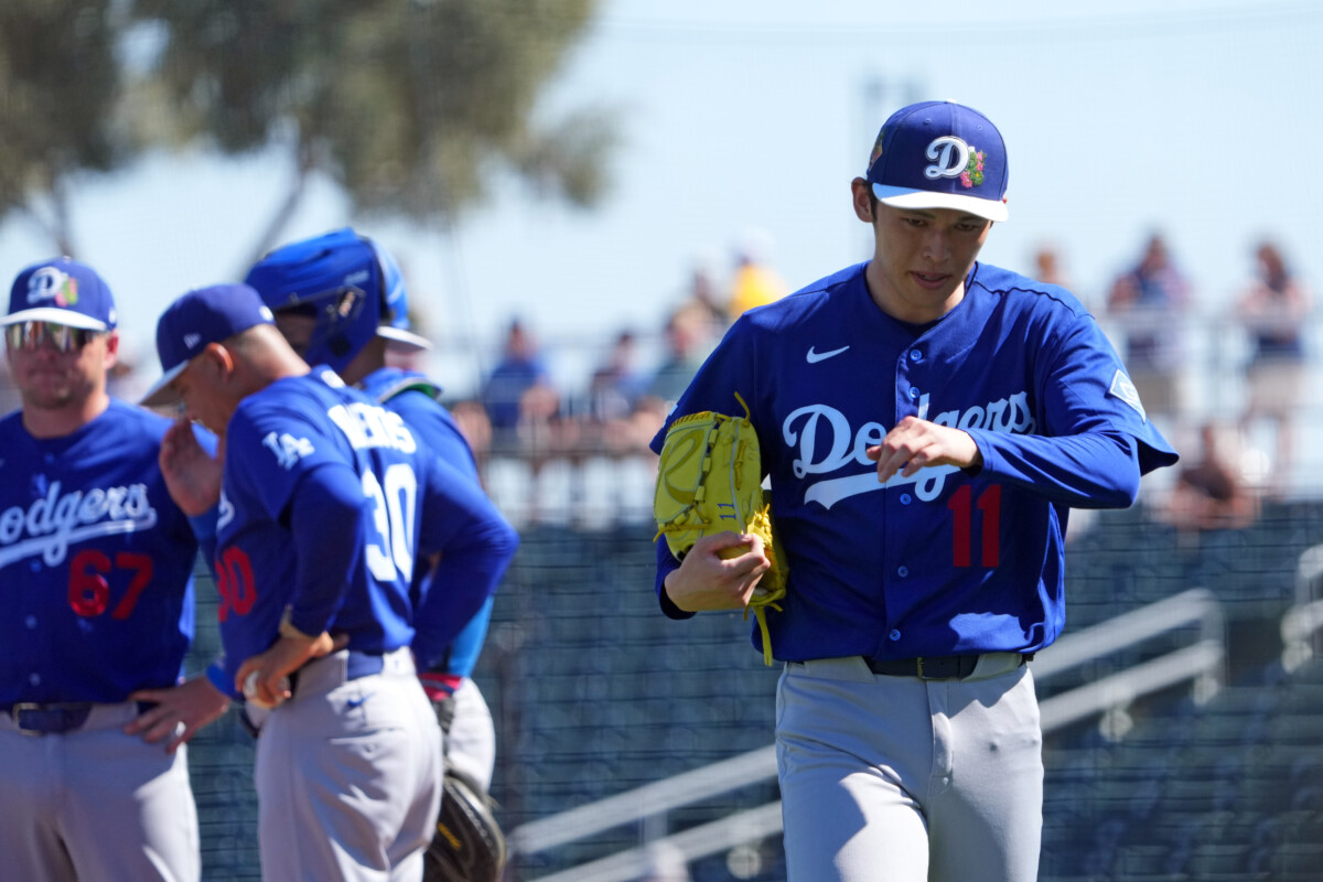 Los Angeles Dodgers starting pitcher Roki Sasaki (11) is taken out f the game by manager Dave Roberts (30) against the Cleveland Guardians during the first inning at Goodyear Ballpark.