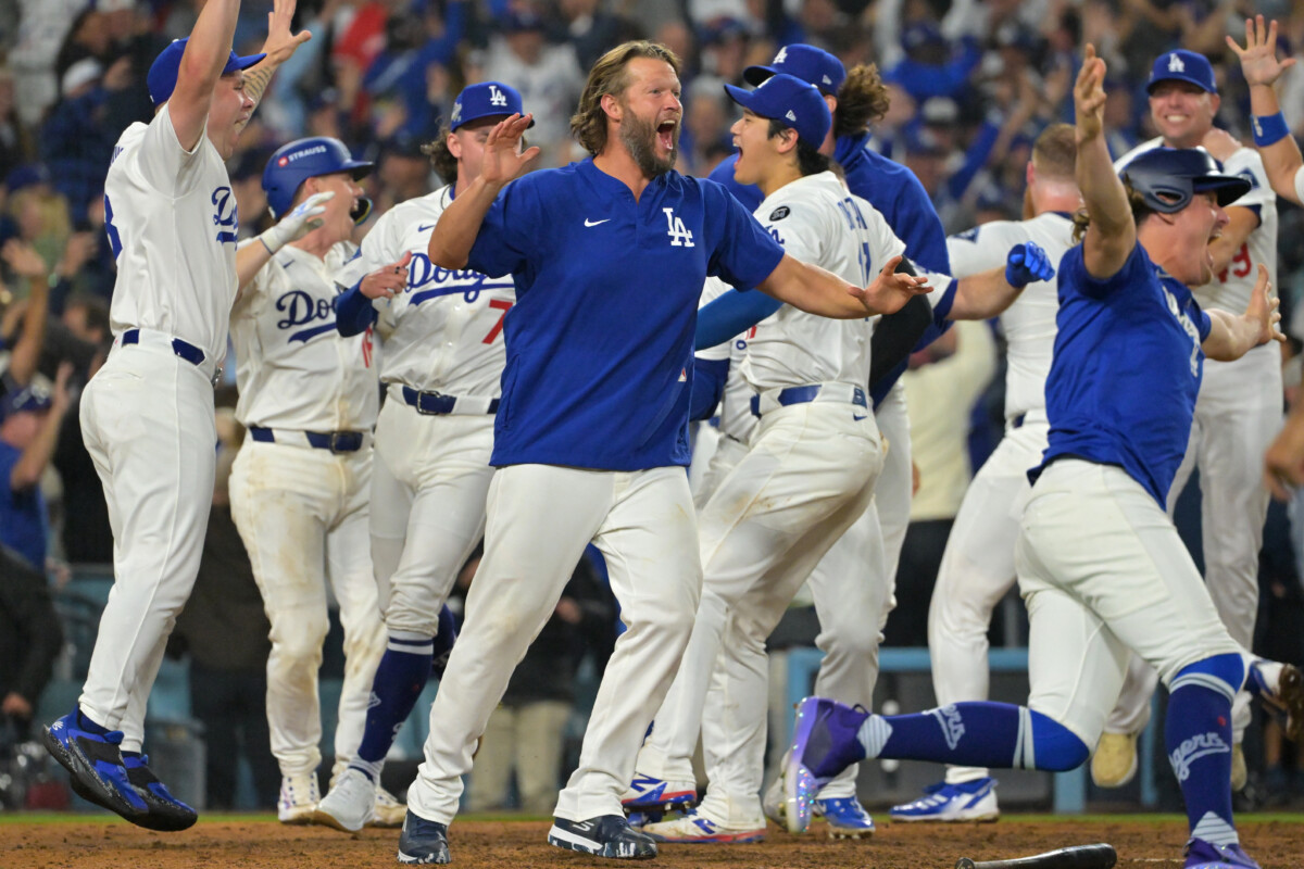 Oct 27, 2025; Los Angeles, California, USA; Los Angeles Dodgers pitcher Clayton Kershaw (22) celebrates with teammates after first baseman Freddie Freeman (5) hit a walk off home run against the Toronto Blue Jays in the eighteenth inning during game three of the 2025 MLB World Series at Dodger Stadium. Mandatory Credit: Jayne Kamin-Oncea-Imagn Images