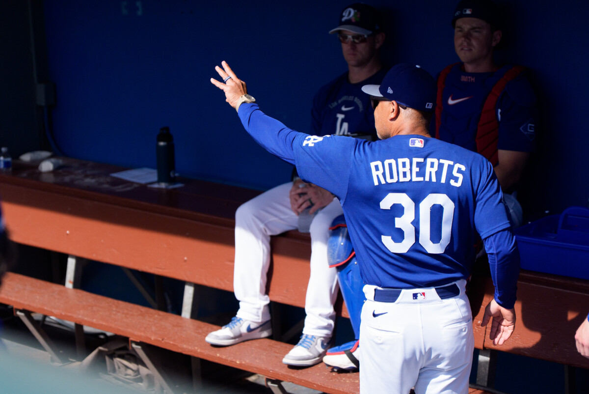 Feb 28, 2026; Phoenix, Arizona, USA; Los Angeles Dodgers manager Dave Roberts (30) greets his team upon arriving in the dugout for a spring training game against the Chicago Cub at Camelback Ranch-Glendale. Mandatory Credit: Allan Henry-Imagn Images