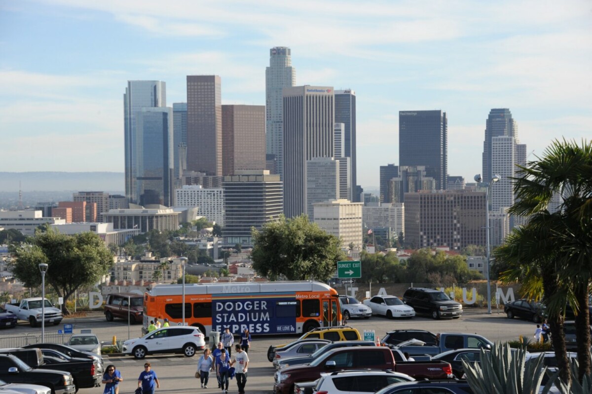 Riders get dropped off at the Top Deck of Dodger Stadium prior to a game in front of the L.A. skyline in this undated image from LA Metro. (LA Metro)