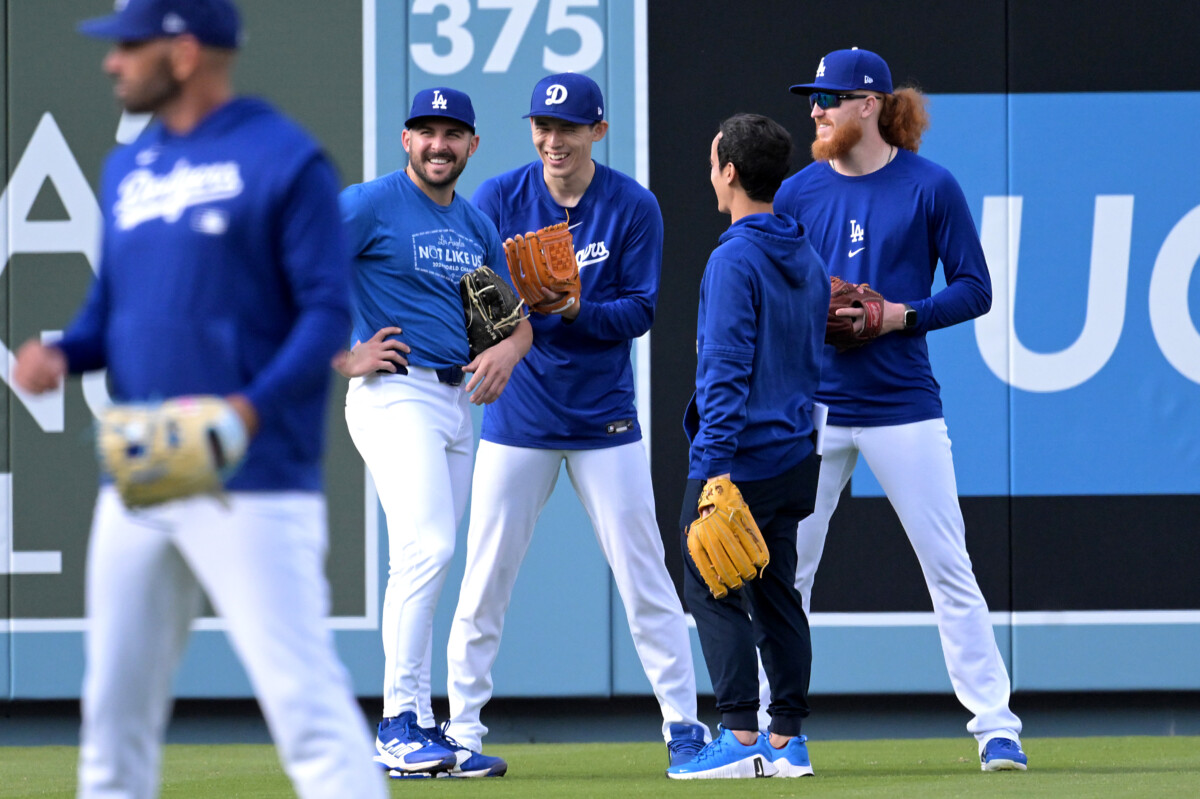 Mar 31, 2025; Los Angeles, California, USA; Los Angeles Dodgers relief pitcher Alex Vesia (51), starting pitcher Roki Sasaki (11), interpreter Will Ireton, and starting pitcher Dustin May (85) in the outfield up prior to the game against the Atlanta Braves at Dodger Stadium. Mandatory Credit: Jayne Kamin-Oncea-Imagn Images