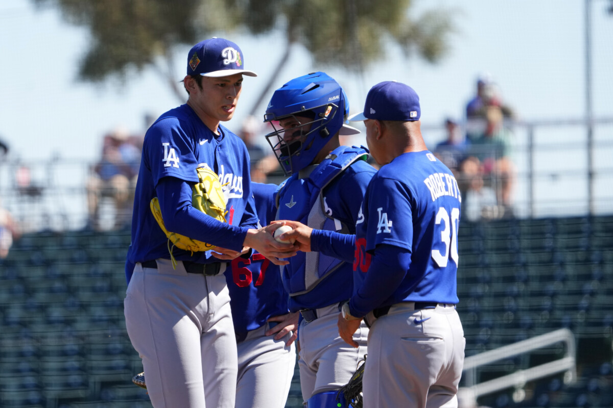 Mar 3, 2026; Goodyear, Arizona, USA; Los Angeles Dodgers starting pitcher Roki Sasaki (11) is taken out f the game by manager Dave Roberts (30) against the Cleveland Guardians during the first inning at Goodyear Ballpark. Mandatory Credit: Joe Camporeale-Imagn Images