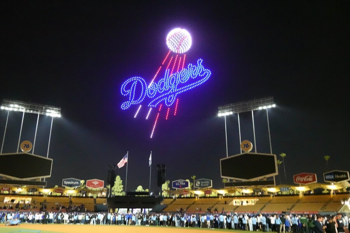 Mar 28, 2025; Los Angeles, California, USA; A Los Angeles Dodgers logo is projected during a drone show at Dodger Stadium. Mandatory Credit: Kirby Lee-Imagn Images