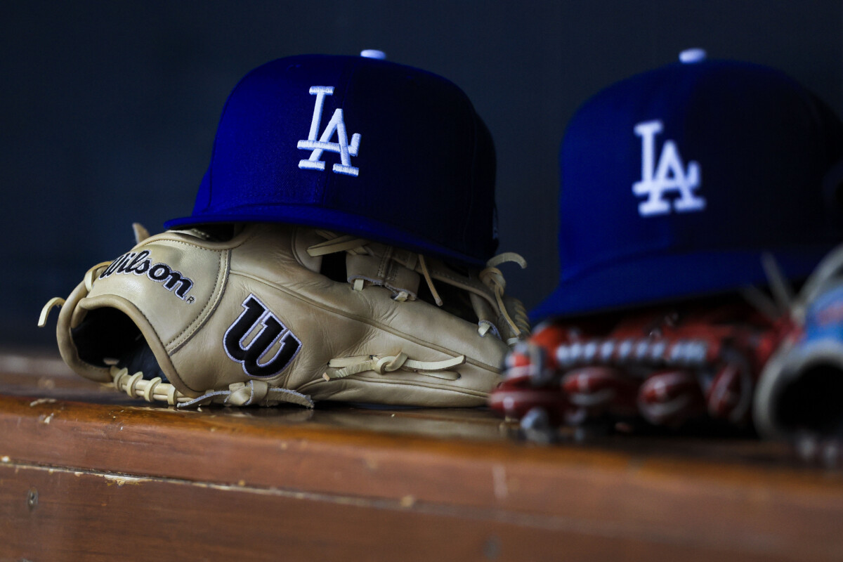 Jul 30, 2025; Cincinnati, Ohio, USA; A general view of a Los Angeles Dodgers hat and glove during the second inning in the game against the Cincinnati Reds at Great American Ball Park. Mandatory Credit: Katie Stratman-Imagn Images