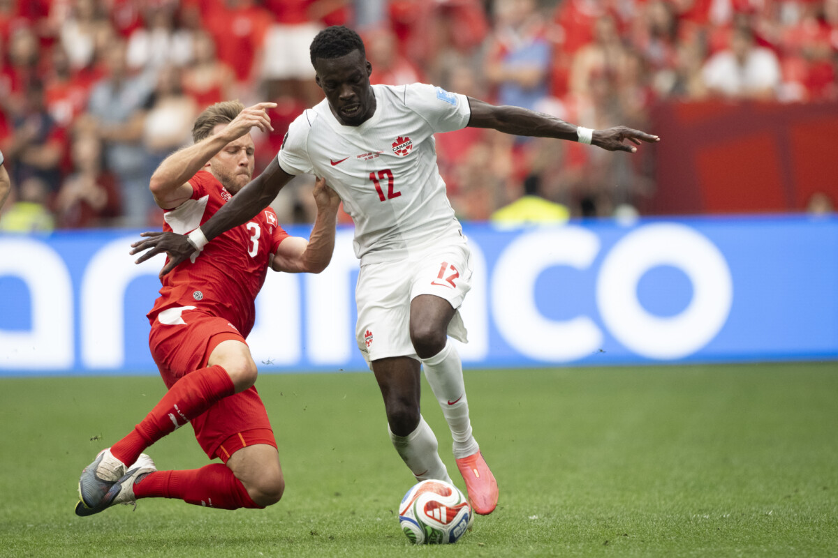 Jun 24, 2026; Vancouver, British Columbia, CAN; Canada forward Tani Oluwaseyi (12) controls the ball against Switzerland defender Silvan Widmer (3) during the second half during a Group B match in the 2026 FIFA World Cup at BC Place Vancouver. Mandatory Credit: Anne-Marie Sorvin-Imagn Images