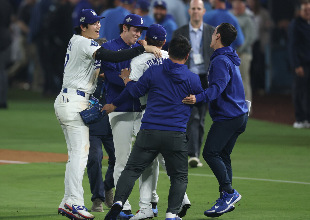 Oct 27, 2025; Los Angeles, California, USA; Los Angeles Dodgers designated hitter Shohei Ohtani (17) celebrates with pitcher Roki Sasaki (11) and pitcher Yoshinobu Yamamoto (18) after winning in the eighteenth inning against the Toronto Blue Jays in game three of the 2025 MLB World Series at Dodger Stadium. Mandatory Credit: Kiyoshi Mio-Imagn Images