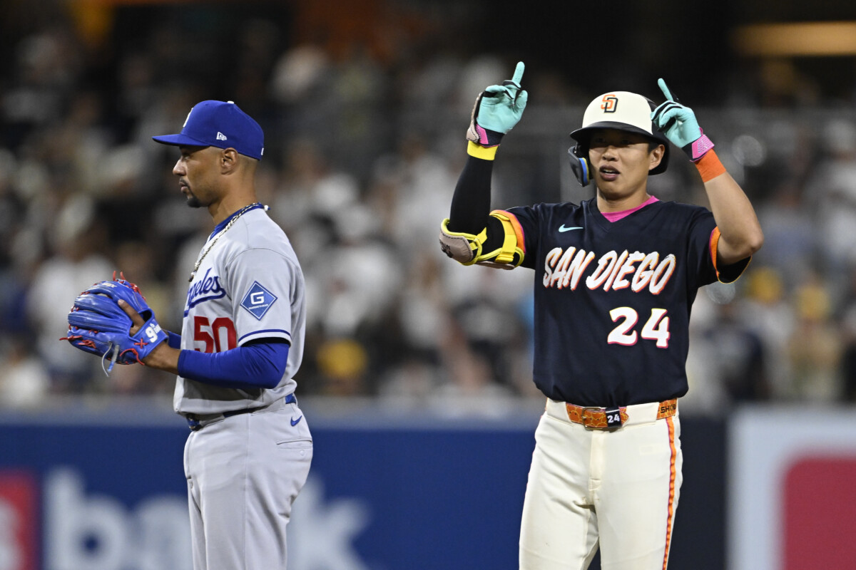Jun 26, 2026; San Diego, California, USA; San Diego Padres second baseman Sung-Mun Song (24) gestures after hitting an RBI single as Los Angeles Dodgers shortstop Mookie Betts (50) looks on during the eighth inning at Petco Park. Mandatory Credit: Denis Poroy-Imagn Images