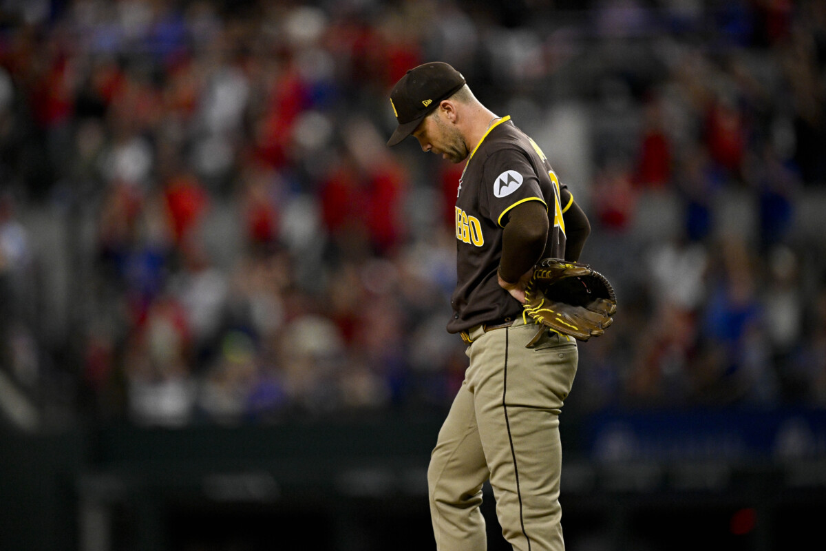 Jun 19, 2026; Arlington, Texas, USA; San Diego Padres relief pitcher Jason Adam looks down after he gives up a home run to Texas Rangers left fielder Wyatt Langford (36) during the eighth inning at Globe Life Field. Mandatory Credit: Jerome Miron-Imagn Images