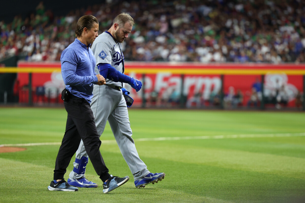 Jun 4, 2026; Phoenix, Arizona, USA; Los Angeles Dodgers third baseman Max Muncy (13) walks off the field with an apparent injury after colliding with Arizona Diamondbacks first baseman Ildemaro Vargas (not pictured) during the fifth inning at Chase Field. Mandatory Credit: Anna Carrington-Imagn Images