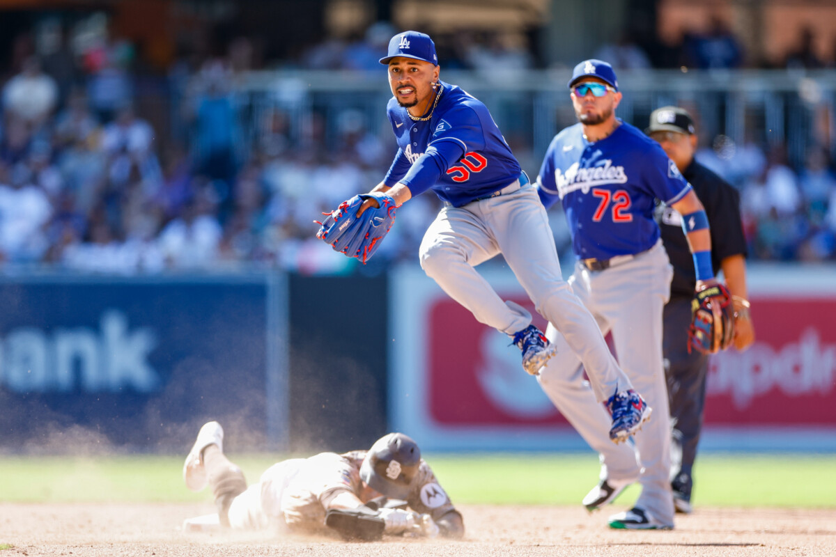Jun 28, 2026; San Diego, California, USA; Los Angeles Dodgers shortstop Mookie Betts (50) turns a double play during the ninth inning against the San Diego Padres to end the game at Petco Park. Mandatory Credit: David Frerker-Imagn Images