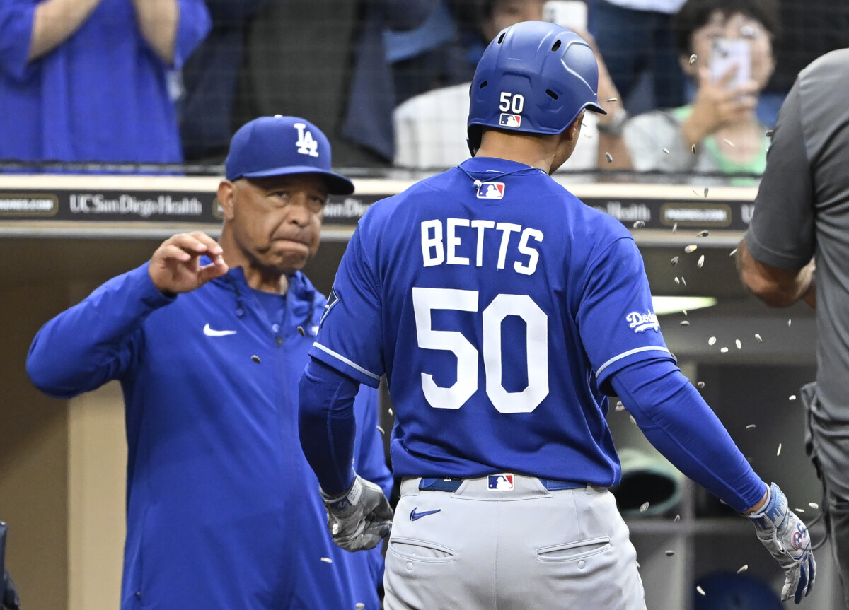 Jun 27, 2026; San Diego, California, USA; Los Angeles Dodgers shortstop Mookie Betts (50) is congratulated by manager Dave Roberts after hitting a three-un home run during the eighth inning against the San Diego Padres at Petco Park. Mandatory Credit: Denis Poroy-Imagn Images