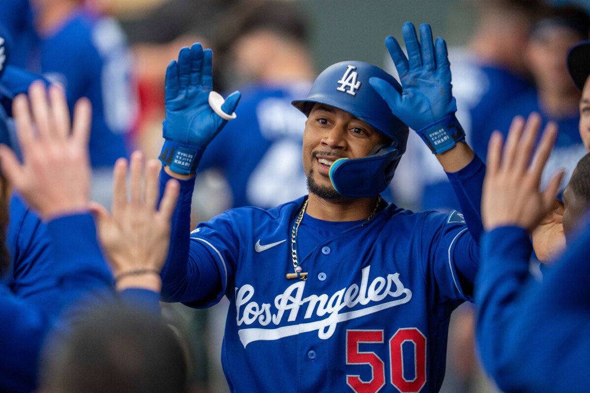 Jun 24, 2026; Minneapolis, Minnesota, USA; Los Angeles Dodgers shortstop Mookie Betts (50) celebrates with teammates in the dugout after hitting a solo home run against the Minnesota Twins in the first inning at Target Field. Mandatory Credit: Jesse Johnson-Imagn Images