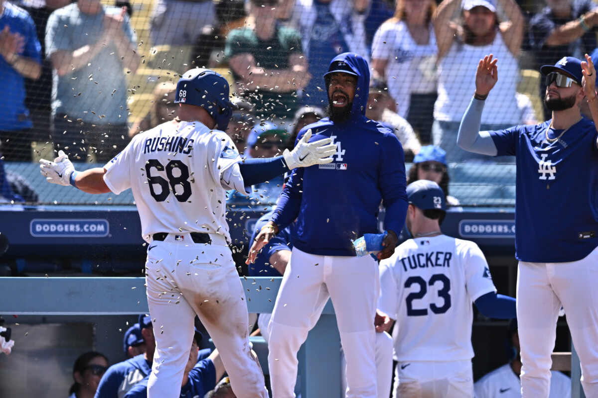 Jun 7, 2026; Los Angeles, California, USA; Los Angeles Dodgers catcher Dalton Rushing (68) gets a sunflower seed shower as arrives back to the dugout after hitting a three-run home run against the Los Angeles Angels during the sixth inning at Dodger Stadium. Mandatory Credit: William Liang-Imagn Images