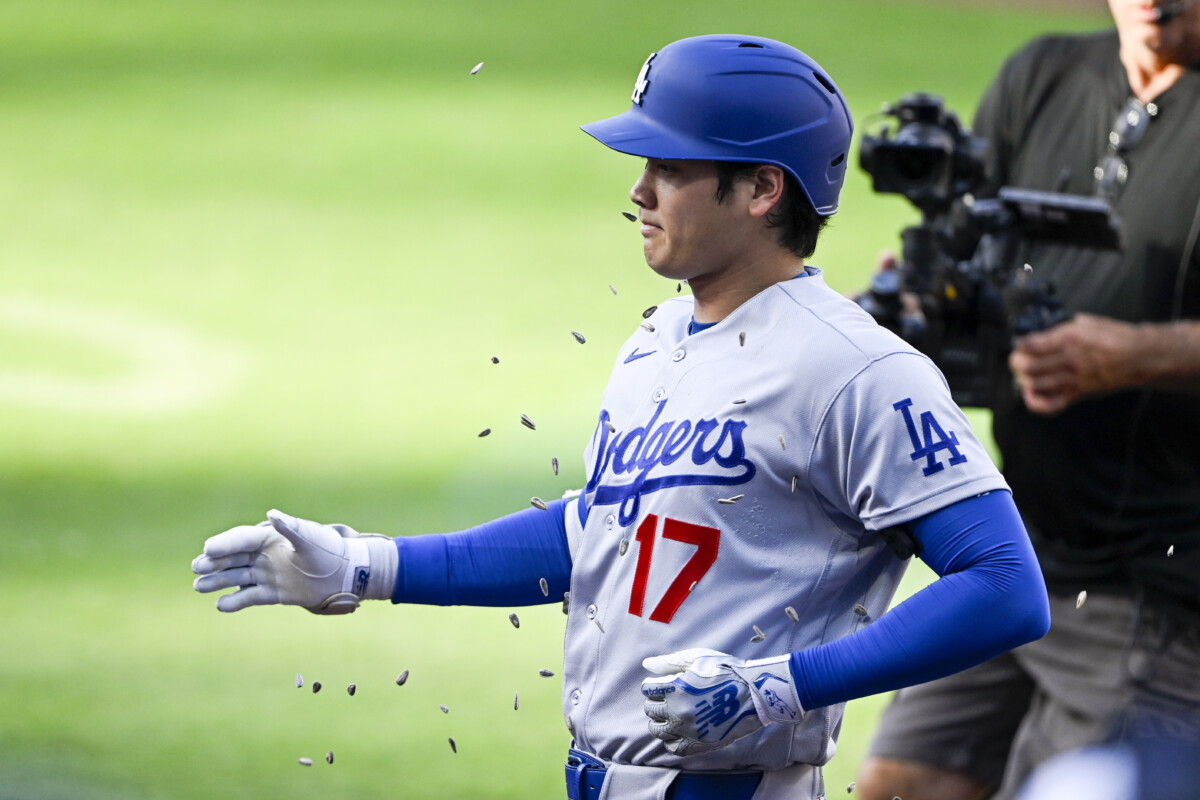 May 20, 2026; San Diego, California, USA; Los Angeles Dodgers designated hitter Shohei Ohtani (17) has seeds tossed on him after hitting a solo home run during the first inning as San Diego Padres third baseman Manny Machado (13) looks on at Petco Park. Mandatory Credit: Denis Poroy-Imagn Images
