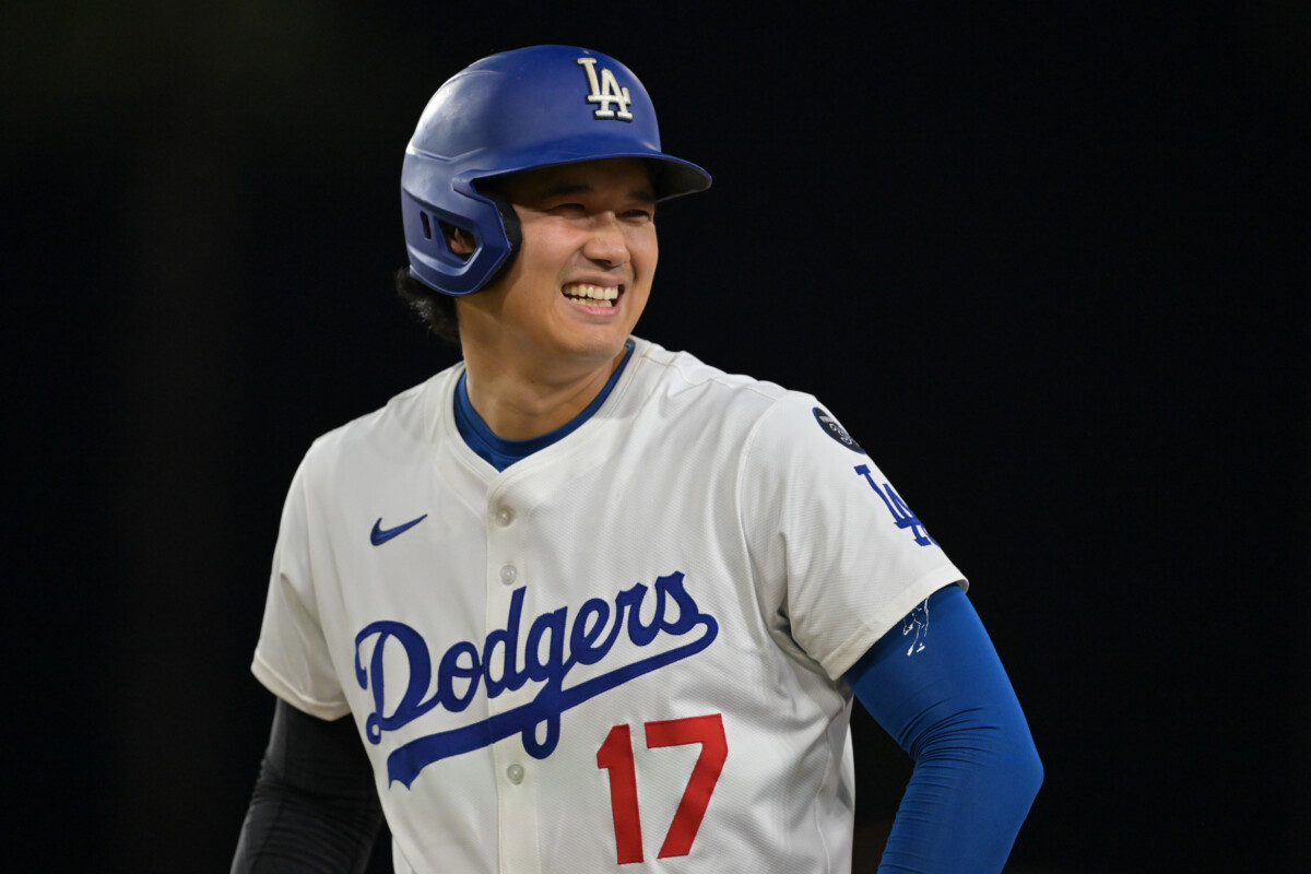Sep 10, 2025; Los Angeles, California, USA; Los Angeles Dodgers designated hitter Shohei Ohtani (17) smiles after he was awarded first base on catcher interference during the eighth inning against the Colorado Rockies at Dodger Stadium. Mandatory Credit: Jayne Kamin-Oncea-Imagn Images