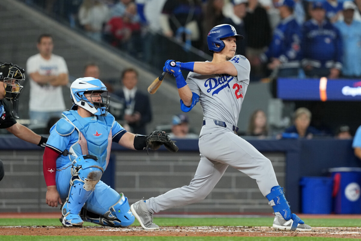 Oct 31, 2025; Toronto, Ontario, CAN; Los Angeles Dodgers second baseman Tommy Edman (25) hits a double against the Toronto Blue Jays in the third inning for game six of the 2025 MLB World Series at Rogers Centre. Mandatory Credit: Nick Turchiaro-Imagn Images