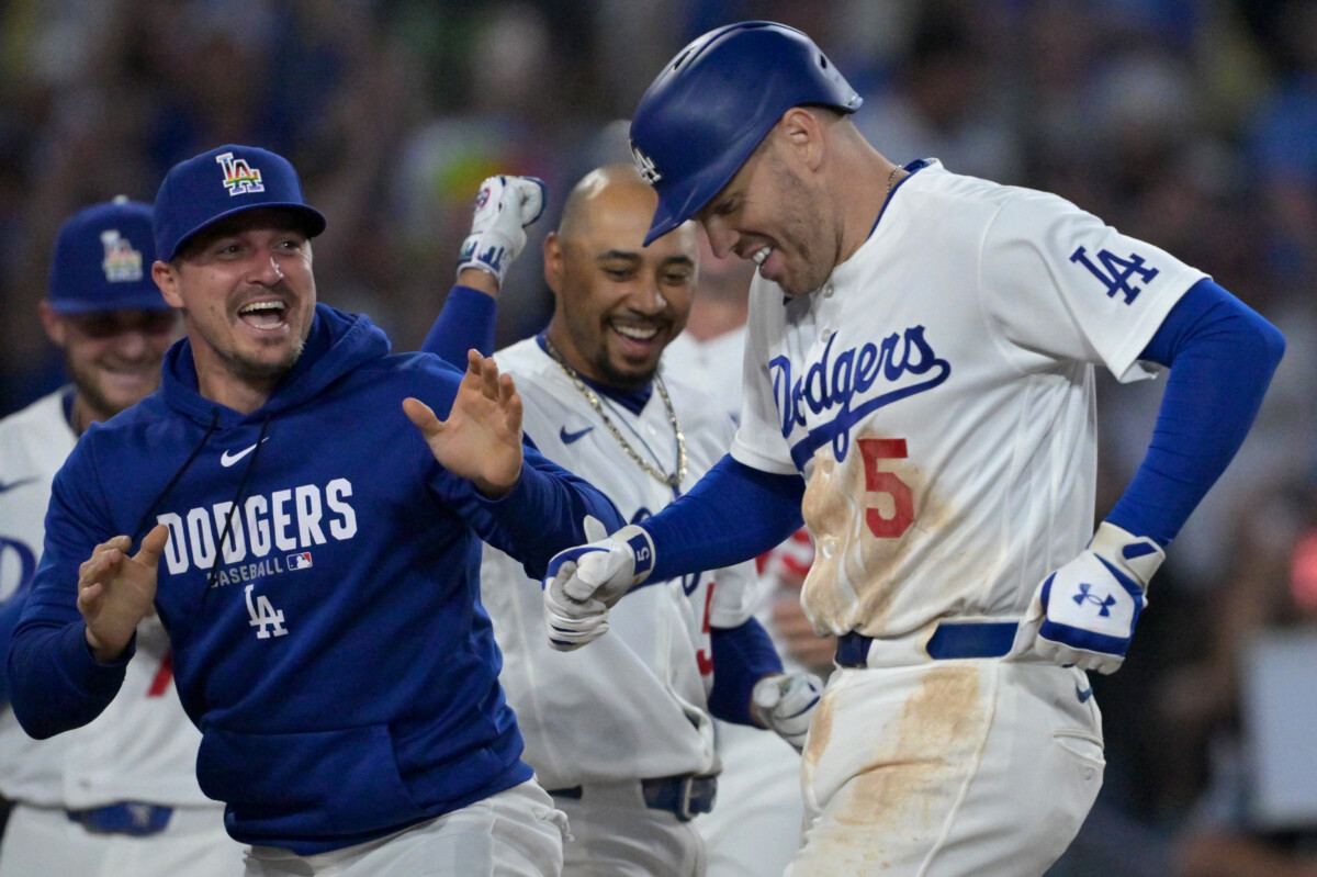 Jun 5, 2026; Los Angeles, California, USA; Los Angeles Dodgers first baseman Freddie Freeman (5) is congratulated by second baseman Enrique Hernandez (8) and shortstop Mookie Betts (50) after hitting a walk-off home run in the ninth inning against the Los Angeles Angels at Dodger Stadium. Mandatory Credit: Jayne Kamin-Oncea-Imagn Images