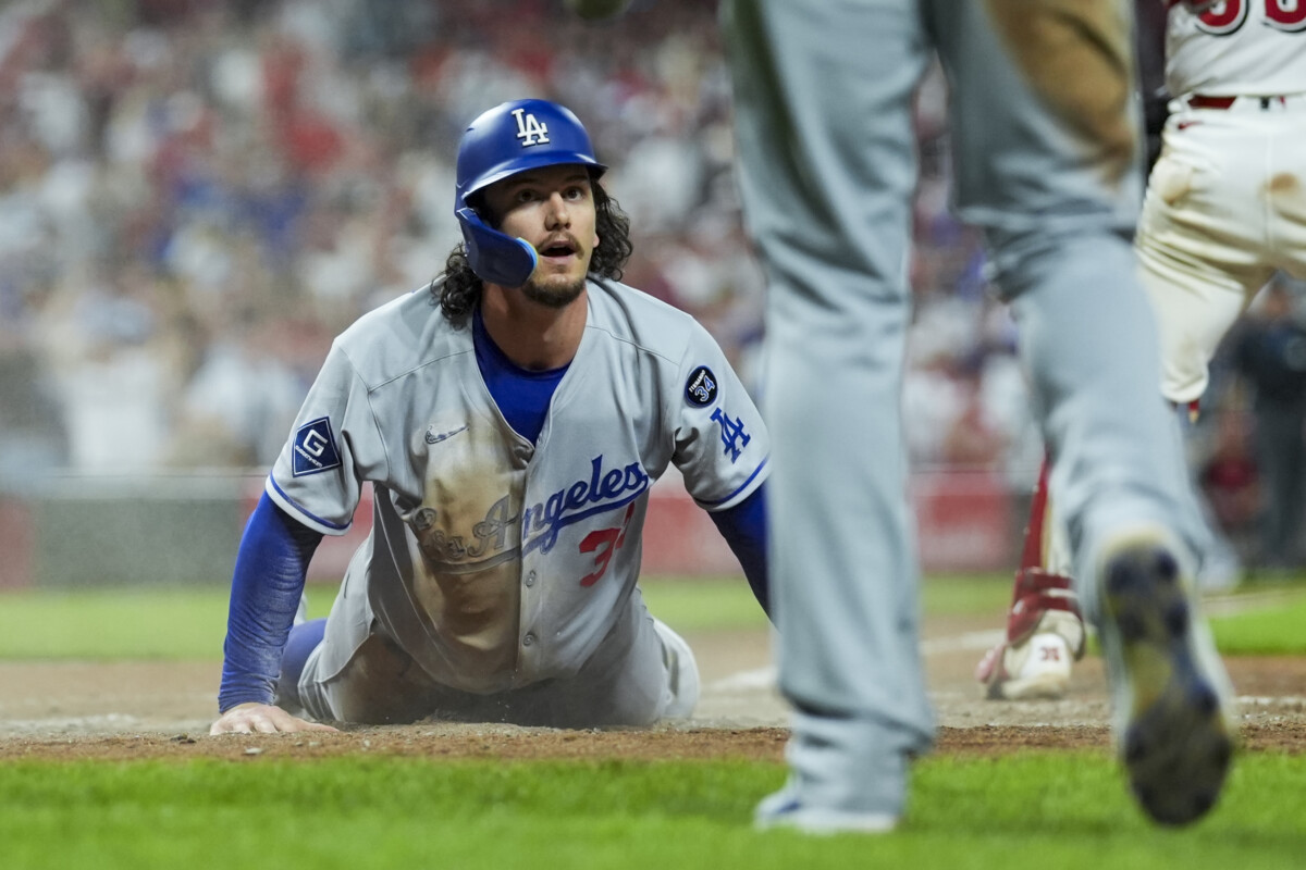 Jul 29, 2025; Cincinnati, Ohio, USA; Los Angeles Dodgers outfielder James Outman (33) scores a run on a double hit by catcher Will Smith (16) in the game against the Cincinnati Reds in the ninth inning at Great American Ball Park. Mandatory Credit: Aaron Doster-Imagn Images