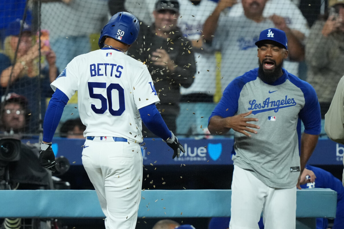 Jun 19, 2026; Los Angeles, California, USA; Los Angeles Dodgers shortstop Mookie Betts (50) is showered with sunflower seeds by Teoscar Hernandez after hitting a home run in the eighth inning against the Baltimore Orioles at Dodger Stadium. Mandatory Credit: Kirby Lee-Imagn Images