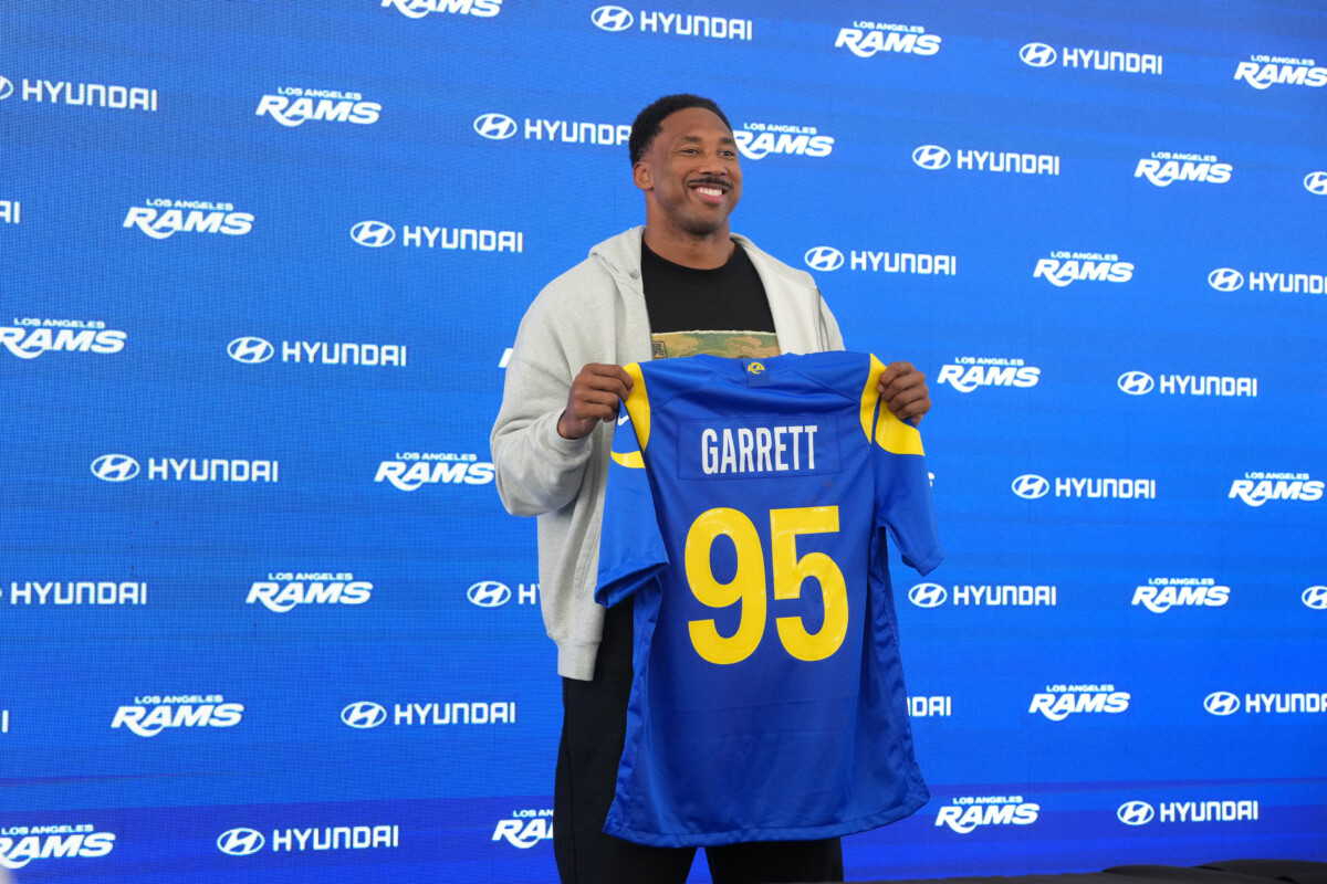 Jun 2, 2026; Woodland Hills, CA, USA; Los Angeles Rams defensive end Myles Garrett (95) poses with jersey at press conference at Rams Practice Facility. Mandatory Credit: Kirby Lee-Imagn Images