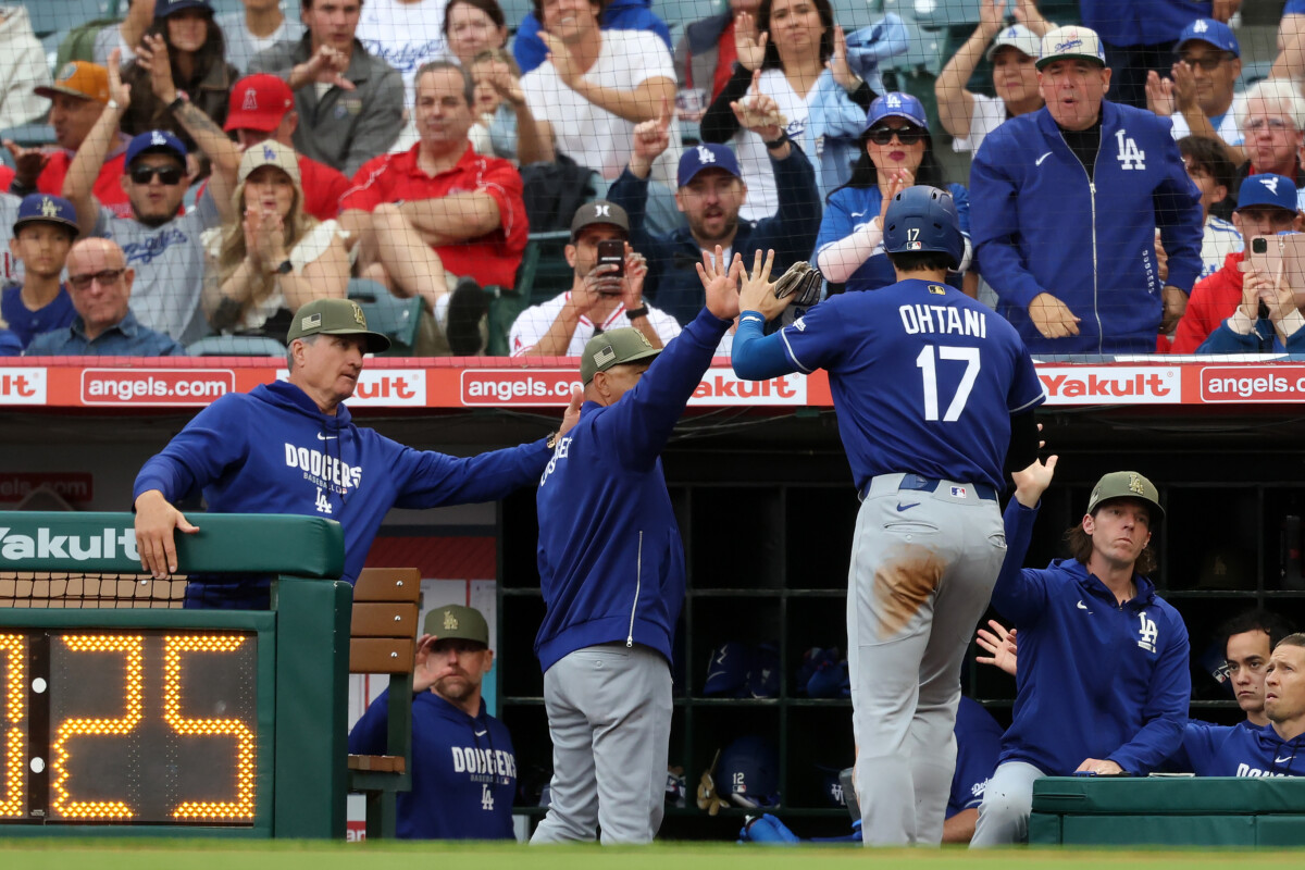 May 16, 2026; Anaheim, California, USA; Los Angeles Dodgers two-way player Shohei Ohtani (17) is greeted by manager Dave Roberts (second from left) after scoring a run during the first inning against the Los Angeles Angels at Angel Stadium. Mandatory Credit: Kiyoshi Mio-Imagn Images