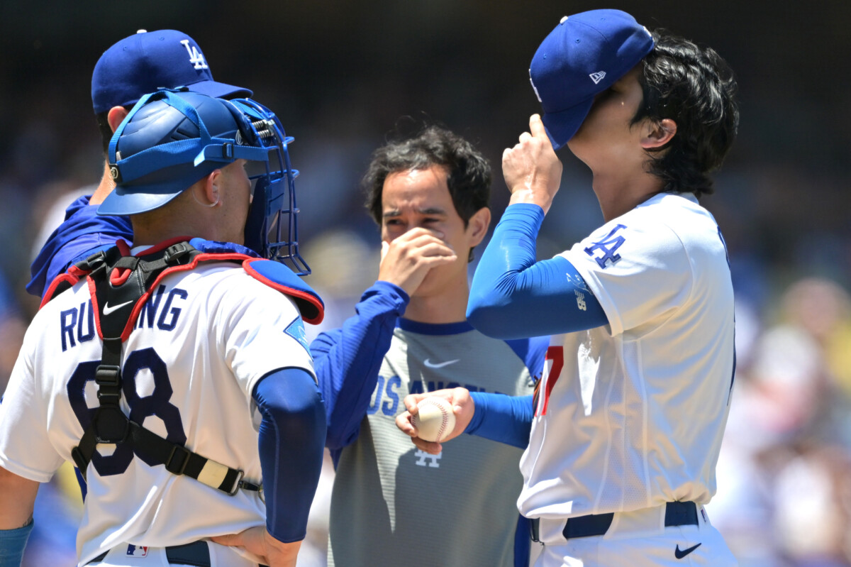 Jun 17, 2026; Los Angeles, California, USA;  Los Angeles Dodgers starting pitcher Shohei Ohtani (17) adjusts his cap as he meets with catcher Dalton Rushing (68), pitching coach Mark Prior (99) and translator Will Ireton on the mound in the fifth inning against the Tampa Bay Rays at Dodger Stadium. Mandatory Credit: Jayne Kamin-Oncea-Imagn Images
