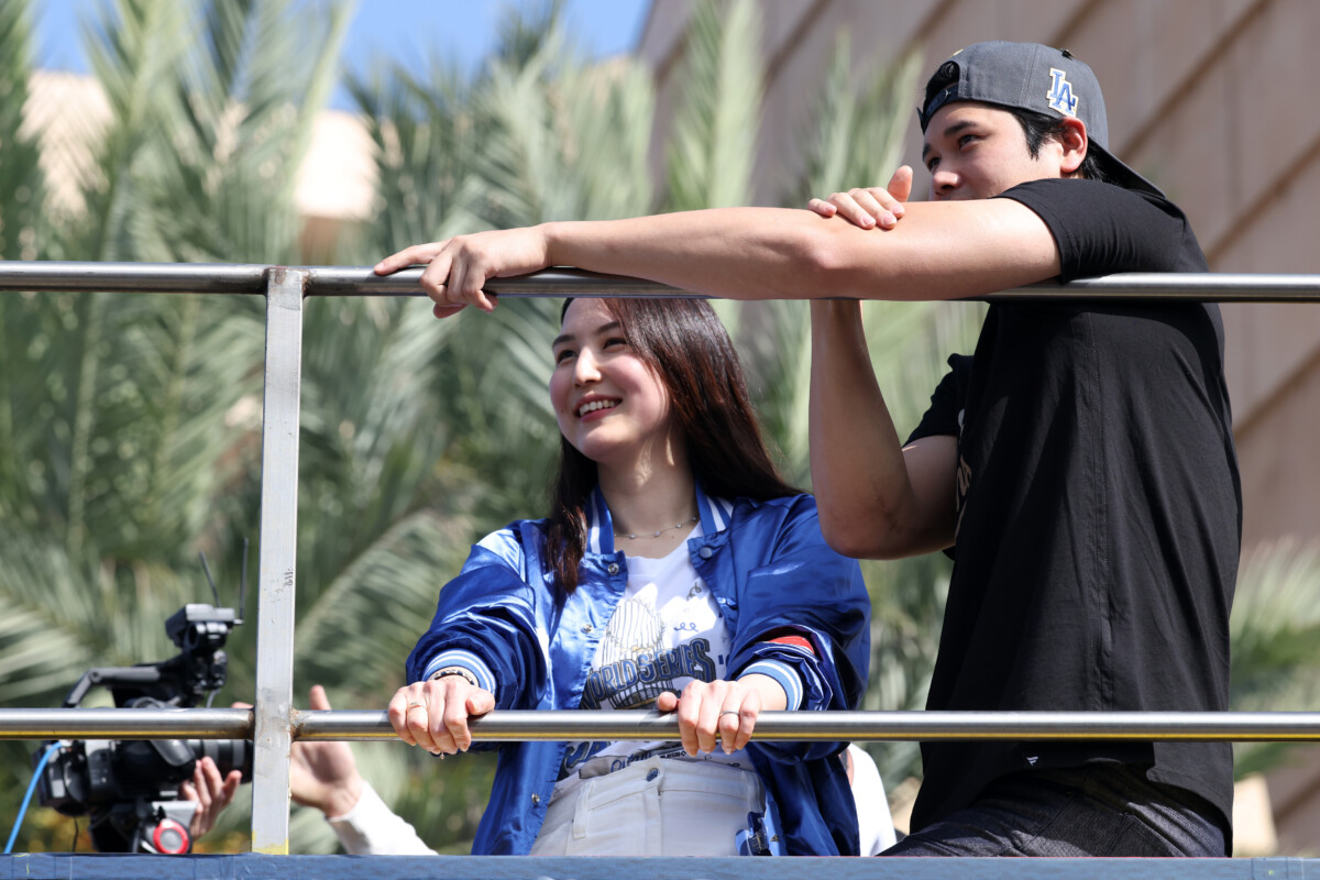 Nov 3, 2025; Los Angeles, CA, USA; Los Angeles Dodgers two-way player Shohei Ohtani and his wife Mamiko acknowledge the crowd during the World Series championship parade at downtown Los Angeles. Mandatory Credit: Kiyoshi Mio-Imagn Images