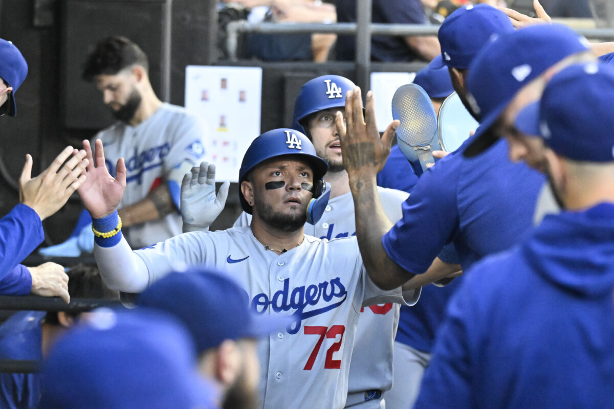 Jun 12, 2026; Chicago, Illinois, USA;   Los Angeles Dodgers shortstop Miguel Rojas (72) celebrates in the dugout after he scores during the second inning against the Chicago White Sox at Rate Field. Mandatory Credit: Matt Marton-Imagn Images