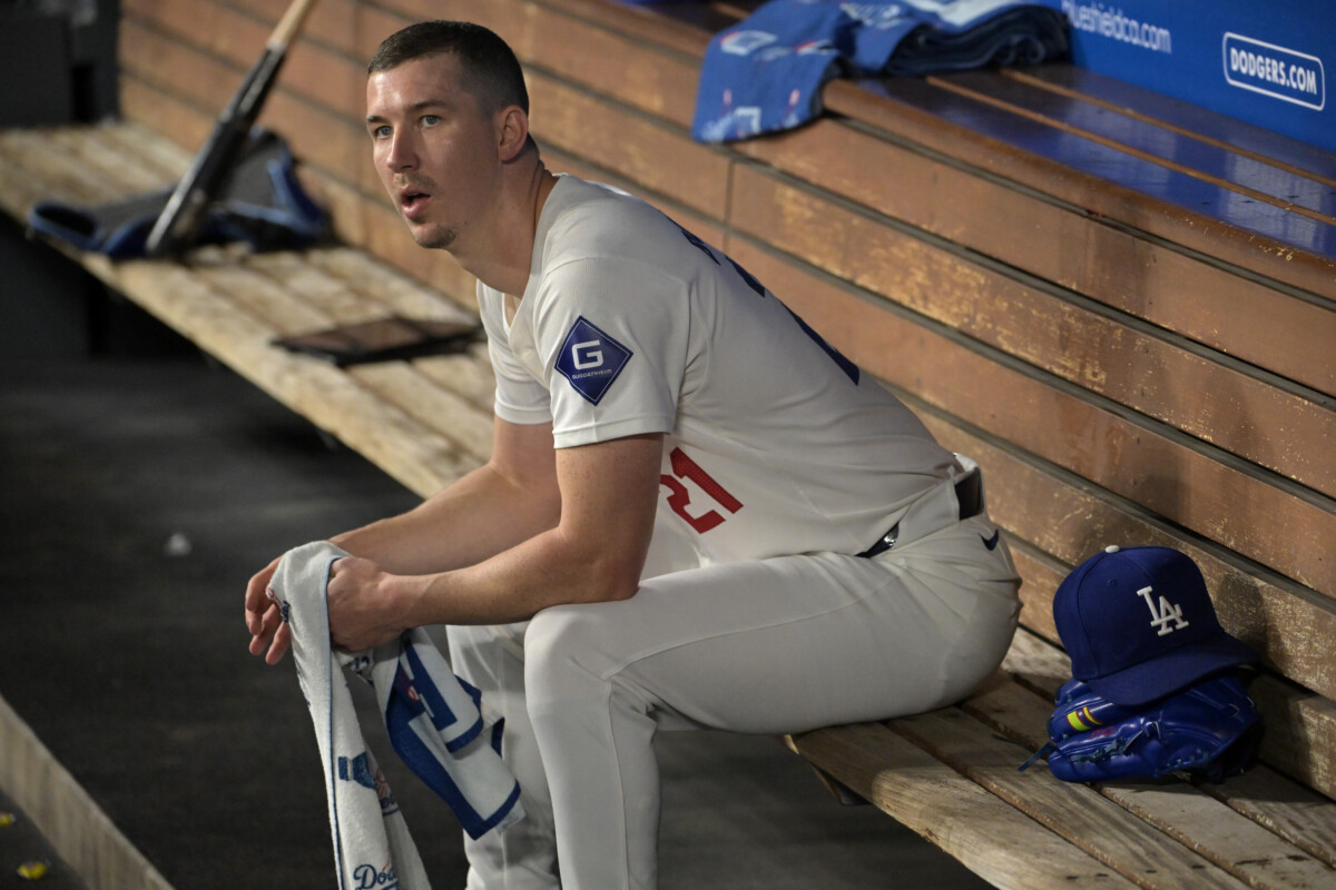 Sep 26, 2024; Los Angeles, California, USA; Los Angeles Dodgers starting pitcher Walker Buehler (21) looks on from the dugout following the second inning against the San Diego Padres at Dodger Stadium. Mandatory Credit: Jayne Kamin-Oncea-Imagn Images