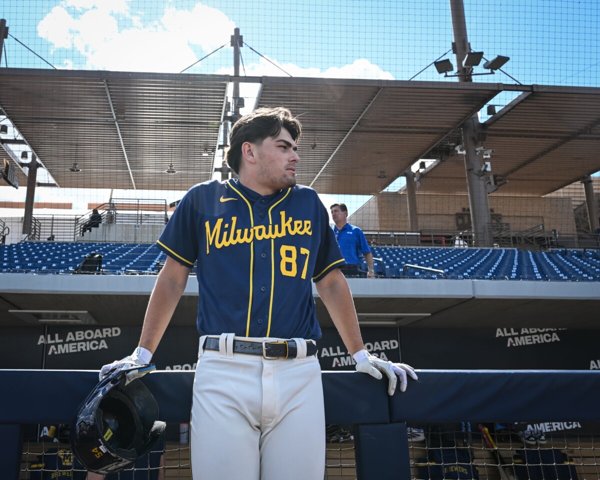 Milwaukee Brewers infield prospect Brady Ebel leans along the dugout rail during spring training workouts Tuesday, February 17, 2026, at American Family Fields of Phoenix in Phoenix, Arizona.