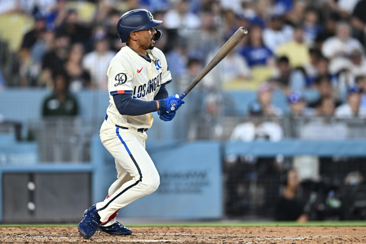 Jul 11, 2026; Los Angeles, California, USA; Los Angeles Dodgers shortstop Mookie Betts (50) hits a RBI single during the sixth inning against the Arizona Diamondbacks at Dodger Stadium. Mandatory Credit: William Liang-Imagn Images