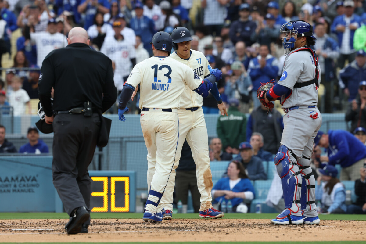 Apr 25, 2026; Los Angeles, California, USA; Los Angeles Dodgers infielder Max Muncy (13) shakes hands with designated hitter Shohei Ohtani (17) at home plate after hitting a two run home run against the Chicago Cubs during the third inning at Dodger Stadium. Mandatory Credit: Kiyoshi Mio-Imagn Images