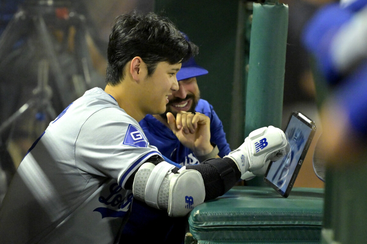 Sep 4, 2024; Anaheim, California, USA; Los Angeles Dodgers designated hitter Shohei Ohtani (17) checks his iPad during the fifth inning against the Los Angeles Angels at Angel Stadium. Mandatory Credit: Jayne Kamin-Oncea-Imagn Images