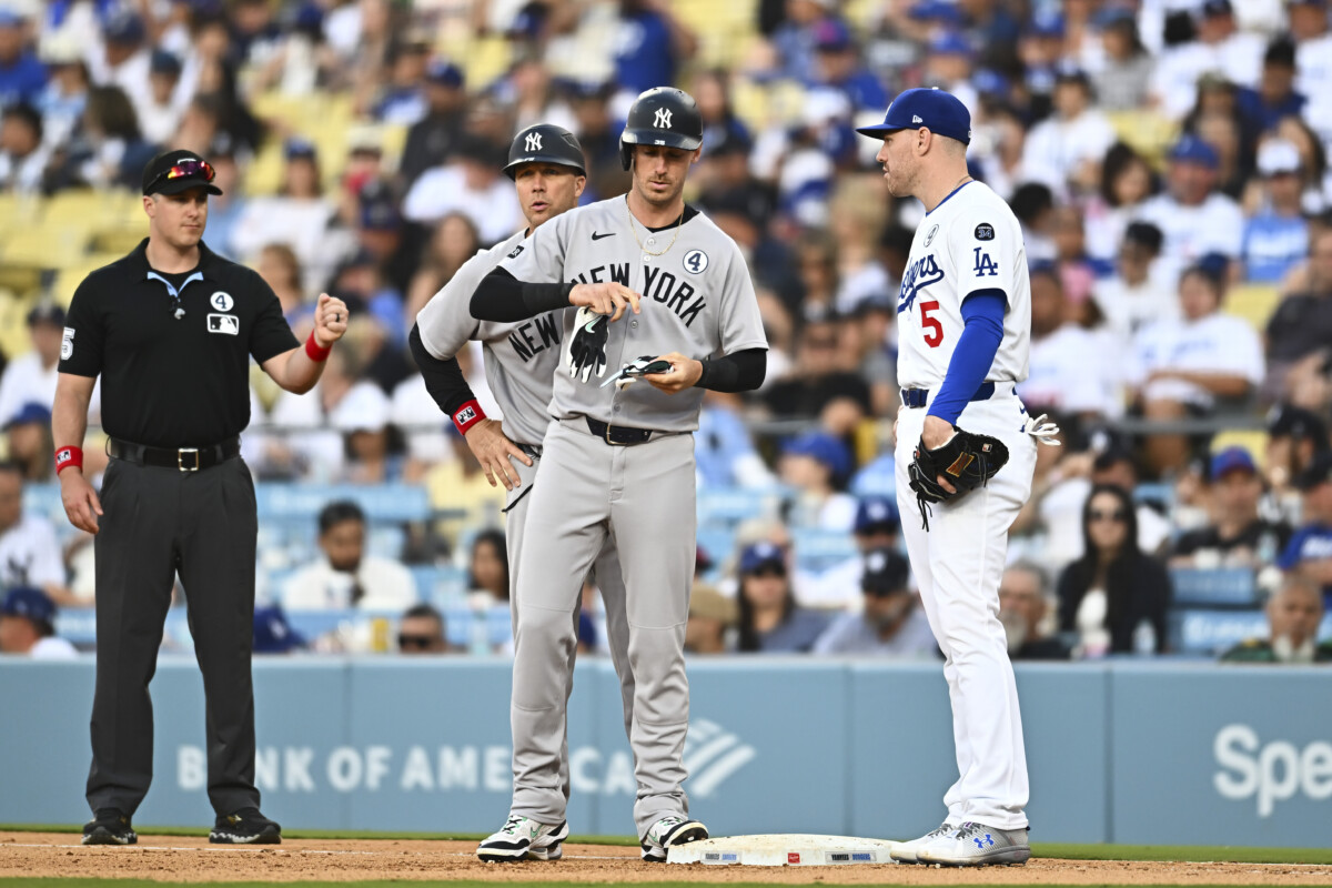 Jun 1, 2025; Los Angeles, California, USA; New York Yankees pinch hitter Cody Bellinger (35) walks against Los Angeles Dodgers first baseman Freddie Freeman (5) during the ninth inning at Dodger Stadium. Mandatory Credit: Jonathan Hui-Imagn Images