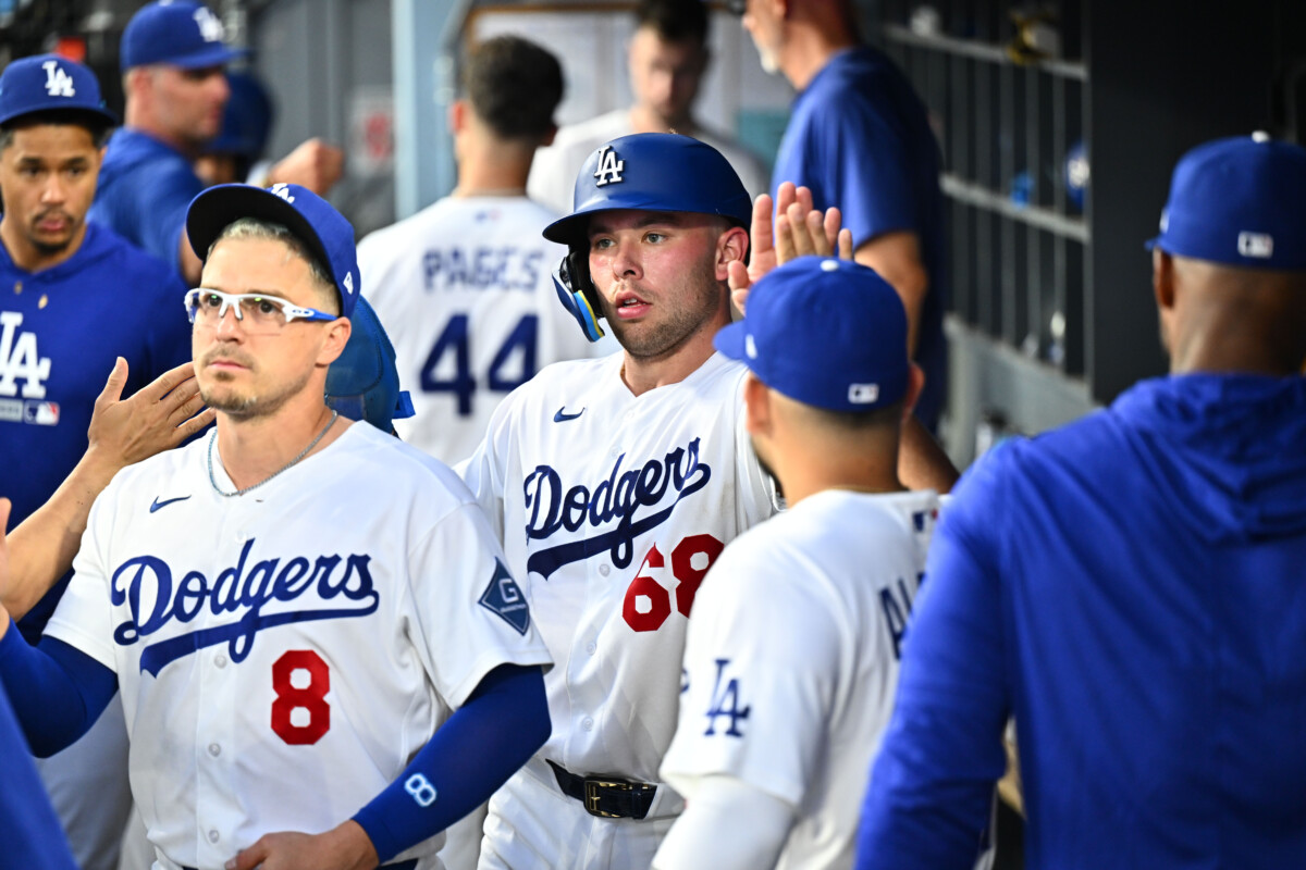 Jul 28, 2026; Los Angeles, California, USA; Los Angeles Dodgers catcher Dalton Rushing (68) is greeted by teammates in the dugout after scoring during the third inning against the Seattle Mariners at Dodger Stadium. Mandatory Credit: William Liang-Imagn Images