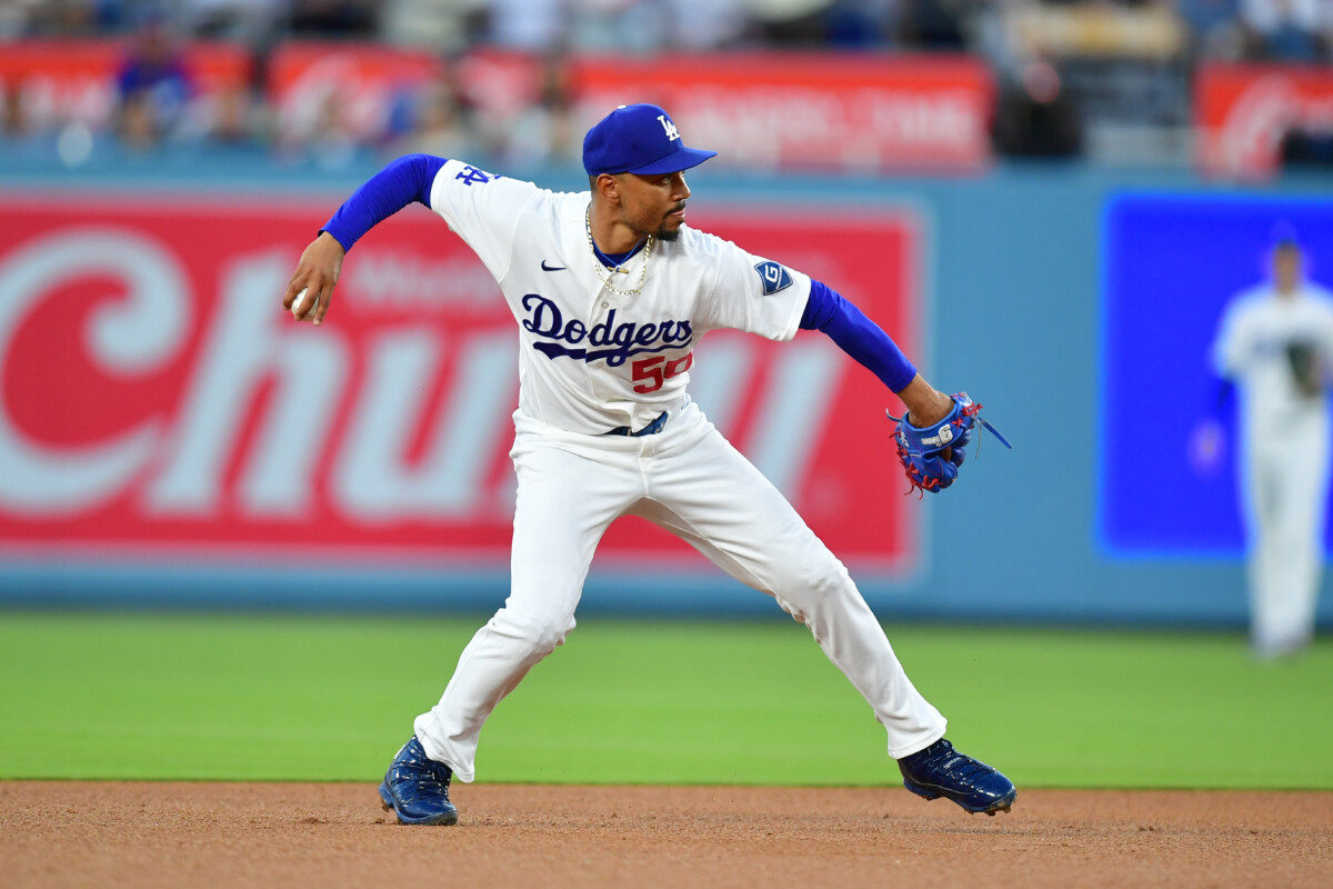 Jul 8, 2026; Los Angeles, California, USA; Los Angeles Dodgers shortstop Mookie Betts (50) throws to first base in the third inning against the Colorado Rockies at Dodger Stadium. Mandatory Credit: Gary A. Vasquez-Imagn Images