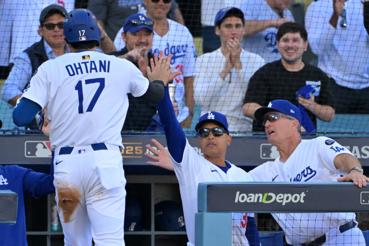 Oct 16, 2025; Los Angeles, California, USA; Los Angeles Dodgers designated hitter player Shohei Ohtani (17) is greeted at the dugout by manager Dave Roberts (30) after scoring a run in the first inning of game three of the NLCS during the 2025 MLB playoffs against the Milwaukee Brewers at Dodger Stadium. Mandatory Credit: Jayne Kamin-Oncea-Imagn Images
