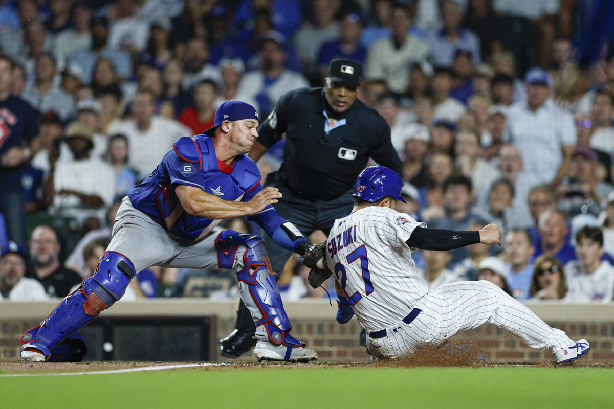 Aug 4, 2026; Chicago, Illinois, USA; Los Angeles Dodgers catcher Ben Rortvedt (47) tags out Chicago Cubs right fielder Seiya Suzuki (27) at home plate during the sixth inning at Wrigley Field. Mandatory Credit: Kamil Krzaczynski-Imagn Images