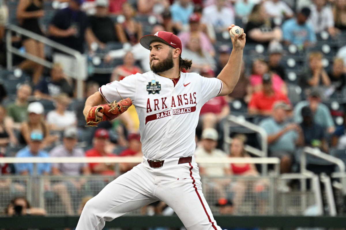 Jun 17, 2025; Omaha, Neb, USA; Arkansas Razorbacks starting pitcher Zach Root (33) throws against the UCLA Bruins during the first inning at Charles Schwab Field. Mandatory Credit: Steven Branscombe-Imagn Images